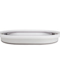 Collapsed Small Taupe White Pop Open Waterproof Plastic Laundry Basket for home, dorm, RV storage; flat side view