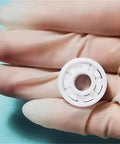 Full Ceramic Bearing ABEC-9 Precision ZrO2 Zirconia Deep Groove Ball Bearing 5x10x4 Millimeters held in a gloved hand.