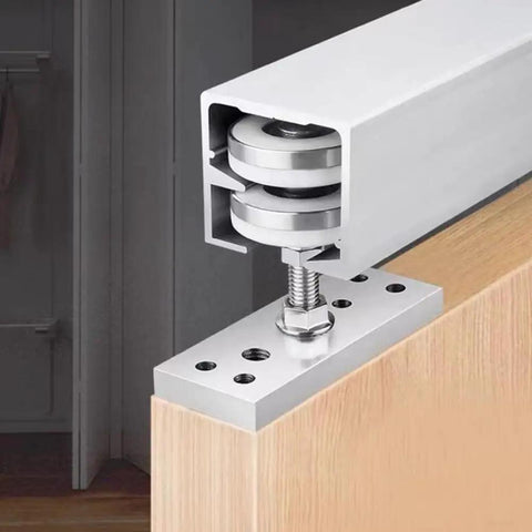 Heavy Duty Folding Door Pulley Featuring Ridiculously Smooth Nylon Rolling Wheel And Rock Solid Zinc Alloy Construction For Zero Hassle Barn Door Hardware Replacement System mounted on wood.