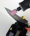 Rotary Tool Grinding Stone Set With One Eighth Inch Shank Aluminum Oxide Bits used to sharpen a knife.