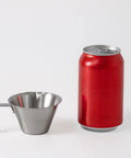 Go-To Stainless Steel Espresso Cup With Handle 3.4oz 100ml Pouring Cup 18/8 next to red soda can, V-shaped mouth and spout visible