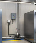 Sanicom 2 Commercial Wastewater Drain Pump Workhorse Badass system installed in a modern laundry facility with pipes and controls.