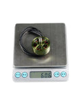 1100KV Brushless Drone Motor For 3 To 6S LiPo Pack on scale showing 60.6 grams