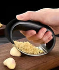 Stainless Steel Garlic Press Rocker Mincer With Peeler And Scraper For Easy Garlic Prep No Mess Rust Resistant Kitchen Gadget in use close-up