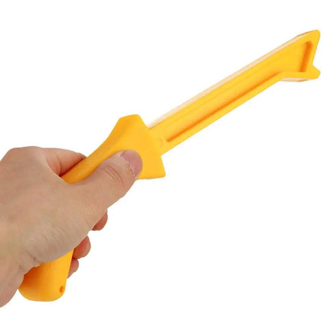 Hand holding woodworking push stick from set for table saw, band saw, and circular saw carpentry with ergonomic ABS handle for tight spaces.