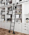 Heavy Duty Sliding Barn Door Hardware Kit in black carbon steel, installed above a white home library with a rolling ladder.