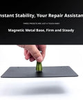 Hand holding Magnetic Soldering Helping Hands Set with Four PCB Holders and Magnetic Pillar Stands on black metal base.