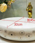 Slick Ceramic Oval Vessel Sink For Modern Bathroom Counters Smooth Glazed Finish with flower design, dimensions 45cm x 30cm x 14cm.