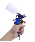 Premium Mini Paint Sprayer With Slick Adjustment Knobs And Hassle Free Setup For Rapid Car Detailing And Smooth As Glass Coatings, lightweight airbrush in hand.
