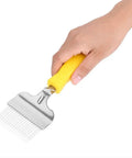 Hand holding stainless steel honeycomb uncapping fork for beekeeping, durable hive tool to remove cells for inspection and rake off excess capping