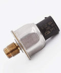 Side view of master cylinder brake fluid pressure sensor; brass threaded connector, silver metal housing, black plastic sensor body.