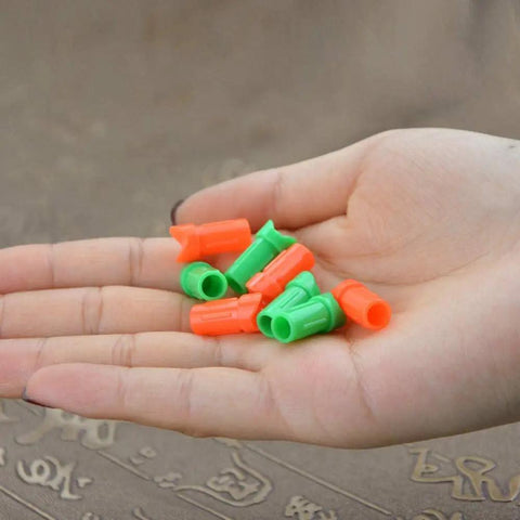 Person holding green and orange plastic 50 Pcs Replacement Half Moon Nocks for 7.7mm ID Crossbow Arrows Bolts for hunting practice