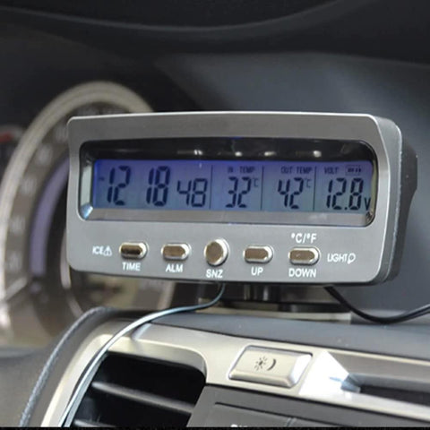 Front view of Riloer 4-in-1 LED car display with blue backlit screen showing time, temperature, and voltage, mounted on dash
