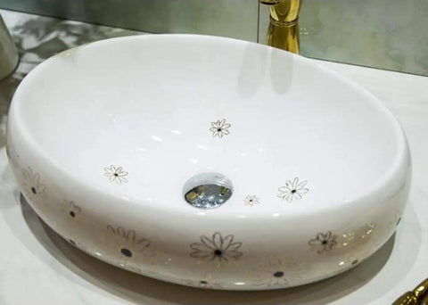Slick Ceramic Oval Vessel Sink For Modern Bathroom Counters Smooth Glazed Finish with floral design and 12 Liter capacity.