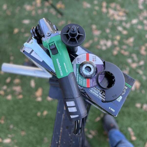 Powerful 4-1/2 Inch Angle Grinder With 12 Amp AC Brushless Motor, Variable Speed, shown with disc, on green background