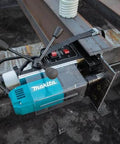 Makita HB350 1-3/8-inch magnetic drill mounted on steel beam with blue body and black handles.