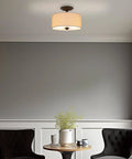 Addison 13 Inch Dope Modern Drum Semi Flush Mount Ceiling Light With Off White Fabric Drum Shade Two Light Fixture In Oil Rubbed Bronze Finish For Kitchen Hallway Living Space, installed in a cozy room setting with chairs.