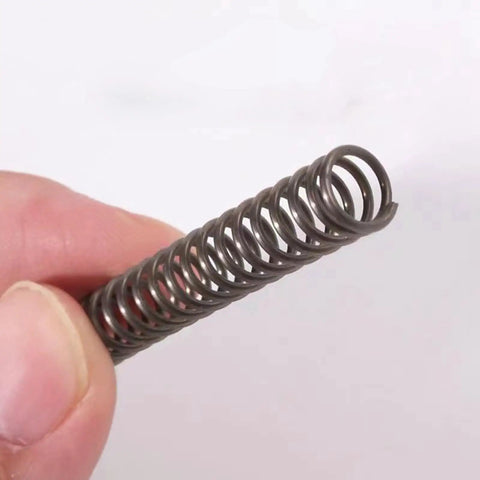 Top Grade Spring Steel Compression Springs With 1.5mm Wire Diameter And 23mm Outer Dimension For 40mm Free Length held in hand.