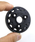 Hand holding black 48P 83T spur gear 4683 upgrade for one tenth scale RC Slash Stampede Rustler Bandit slipper clutches