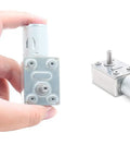 Person holding a 12V 30RPM High Torque DC Worm Gear Motor for DIY Robots, showing 6mm shaft, compact body, reversible low RPM reducer