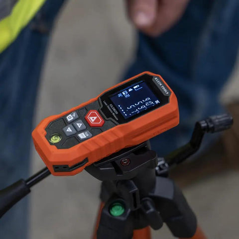 Green Laser Distance Measure Tool With 200 Foot Range for DIY and pros, USB rechargeable on tripod, close-up view.