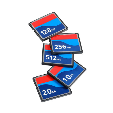 Various Compact Flash memory cards stacked, showing 128MB, 256MB, 512MB, 1.0GB, and 2.0GB sizes for digital cameras and gear.
