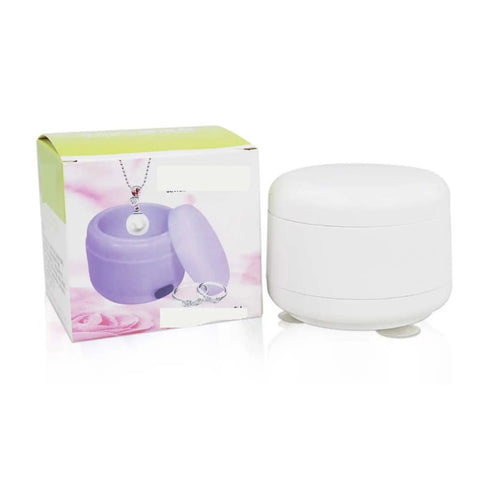 Compact Premium Portable Ultrasonic Cleaner For Jewelry And Watches beside purple packaging, perfect for home and travel use.