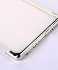 Close-up of a shiny metallic phone case with button cutouts, corner view.