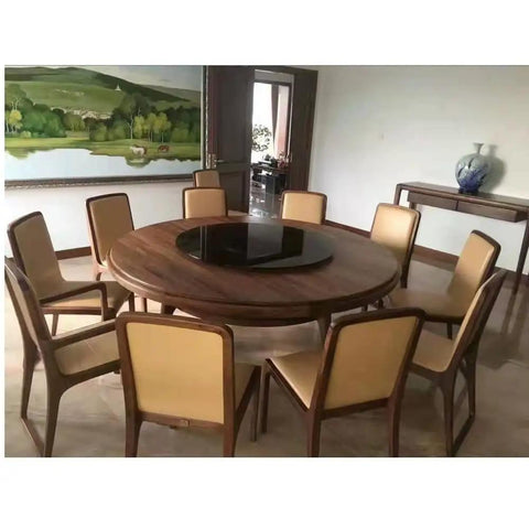 Black Tempered Glass Lazy Susan Turntable Serving Tray, 28 Inch Round Base With Heavy Duty Swivel Mechanism displayed on a round dining table.
