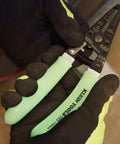 Hands holding Glow In The Dark Grips Wire Stripper And Cutter With Serrated Curve Nose For 10 To 18 AWG Solid And 12 To 20 AWG Stranded Wire Pro Grade Tool Made In USA.