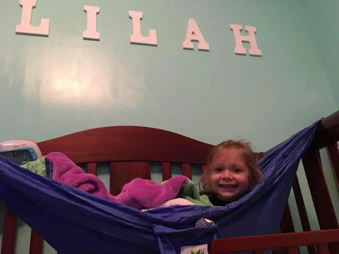 Kid Friendly Camping Hammock For Indoors And Outdoors with child in blue hammock, easy setup in bedroom, great starter hammock for kids.