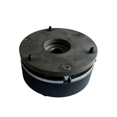 Front view of circular holding brake assembly for servo motor; dark metal housing, central bore, four screws.
