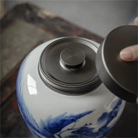 Solid Ceramic Tea Canister For Loose Leaf Storage, Airtight Kitchen Jar with moisture-proof lid being opened.