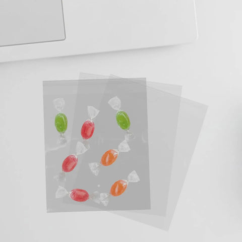 100 Pack Self Sealing Candy Bags Resealable BOPP Bags with colorful candies inside, shown on a white surface