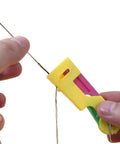 Person using 3 Pack Automatic Needle Threaders For Sewing Machines Easy No Fuss Threading Tool Durable Plastic Colors Vary Green Yellow Red.