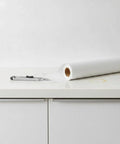 Self Adhesive Wallpaper Roll Subtle Gray Linen Texture Waterproof Vinyl Peel and Stick Film on countertop with cutter