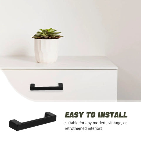 Vintage Zinc Alloy Cabinet Handles Matte Black For Kitchen And Dresser Drawers shown on white cabinet with plant