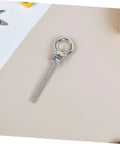Single stainless steel threaded eyebolt M10x100mm with ring shown on a light surface for industrial and construction use