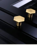 10 Pack 1.3 Inch Gold Cabinet Knobs Solid Brass Hexagon Drawer Pulls on black cabinet surface