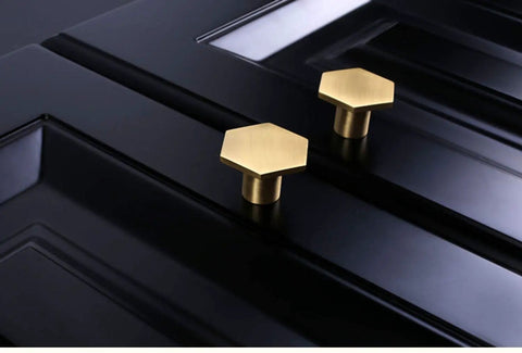 10 Pack 1.3 Inch Gold Cabinet Knobs Solid Brass Hexagon Drawer Pulls on black cabinet surface