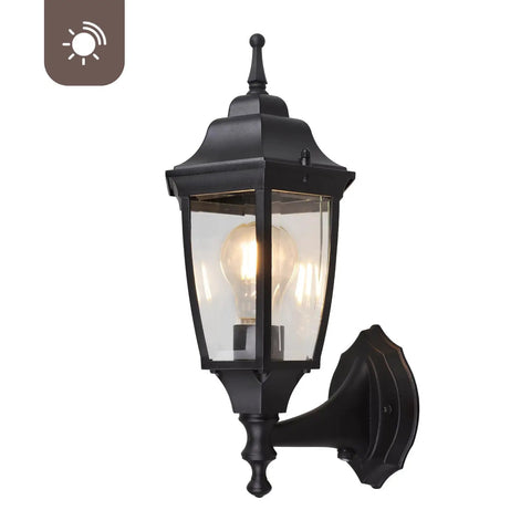 Photocell Dusk To Dawn Outdoor Wall Light With Weatherproof Die Cast Aluminum And Glass Hands Free Auto On Off Wet Location Rated E26 Base 60W Max Ideal For Porch Garage And Garden Black Finish showing side view with illuminated bulb.