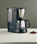 Black Stainless Steel Coffee Maker With 6 Cup Mesh Filter EC AS60 XB No Fuss Auto Brew For Rich Flavor And Quick Morning Wake Up Easy Clean Design For Home Use showing side view.