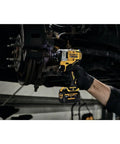 Mechanic using Xtreme 12V Max Brushless One Half Inch Cordless Impact Wrench Tool Only on car wheel bolts