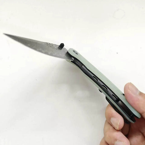 Damascus Pocket Folding Knife With 3.26 Inch Sharp Blade And G10 Handle shown open in hand