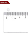 White 5 mm ceramic zirconia bearing ball shown next to a ruler for scale