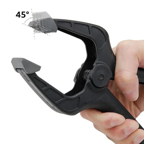 Hand holding a black nylon spring clamp from the 14 Piece Nylon Spring Clamp Set For Photography, Woodworking And Crafts at a 45-degree angle.