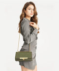 Olive green quilted crossbody handbag with gold turn-lock clasp and chain strap