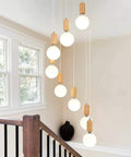 Top Shelf Three Head Disc Pendant Ceiling Light With Milky Frosted Glass Lampshades And Heavy Duty Wrought Iron Frame for modern stairway decor.