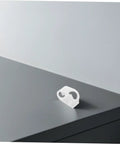 Single white clamp from the 20 Adjustable Flow Control Clips For Tubes Plastic Hose Clamps collection on a gray surface.