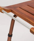 Close-up of teak wood bath shower stool with non slip feet height adjustable lightweight shower bench for seniors ergonomic bath chair